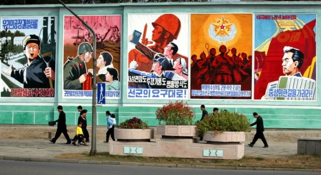 Pyongyang — the propaganda doesn’t hide. Murals, loudspeakers, portraits: the machine in plain sight.
